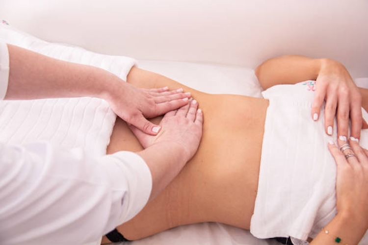 Woman doing massage, lymphatic drainage and beauty treatments in a spa clinic.
